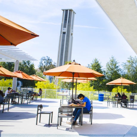 Student enjoying a sunny day outside the Food Court at UCR