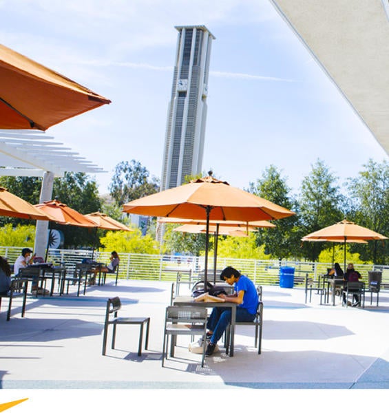 Student enjoying a sunny day outside the Food Court at UCR